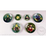 A collection of six Moorcroft pin dishes,