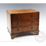 A 19th century oak and pine apprentice chest, of three long drawers, on bracket feet,