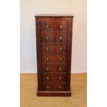 A gun cabinet modelled as a Regency Wellington chest,