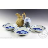 A selection of ceramics to include a set of three Chinese ming style blue and white carp bowls,