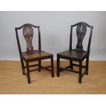 A near set of four George III provincial oak dining chairs,