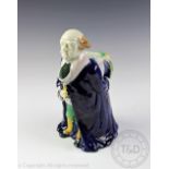 A Joseph Holdcroft style Majolica pitcher, modelled as a Judge wearing a long blue robe,