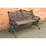 A Coalbrookdale style cast iron garden bench, with floral frame, on scroll legs,
