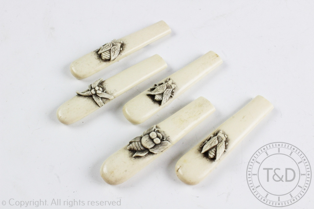 A set of five Japanese carved bone handles, each carved with an insect and unmounted, signed,