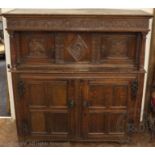 A late 17th century oak court cupboard, with later carved detailing,