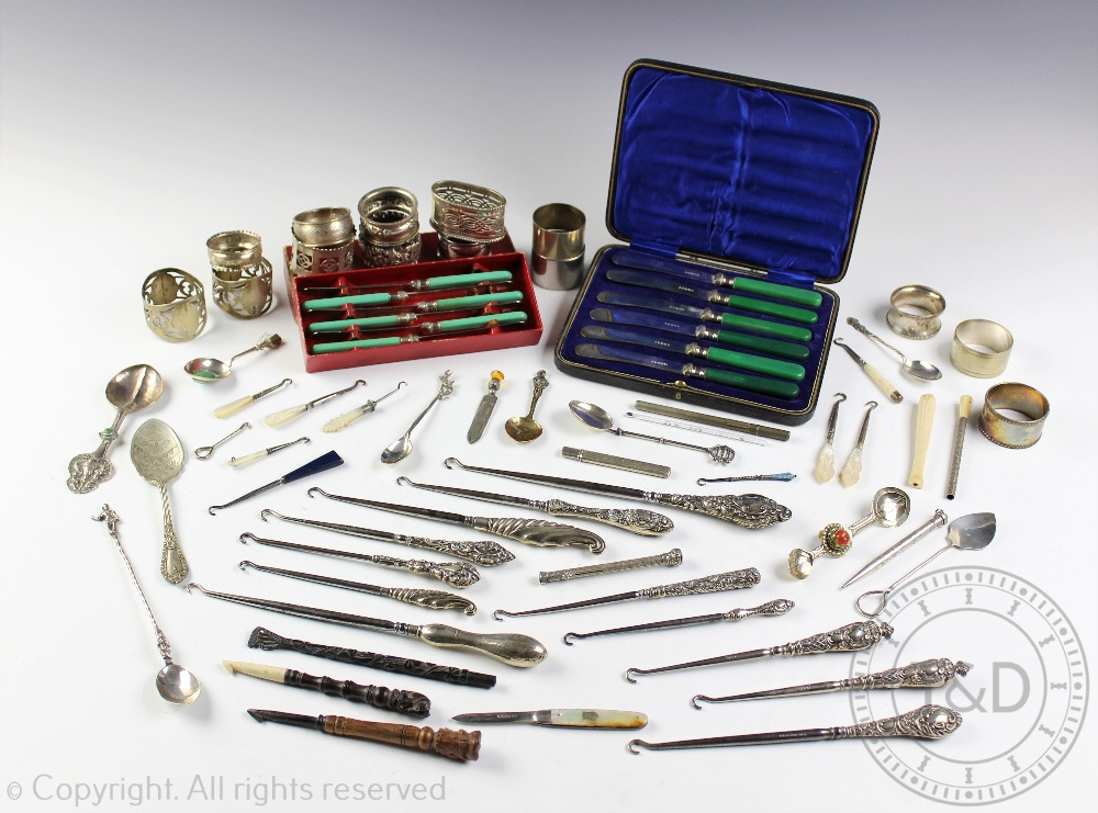 A mixed collection of silver and plated wares, to include Victorian and later boot hooks,