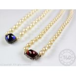 Two imitation pearl necklaces with large cabochon set clasps,