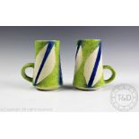 A pair of Paul Jackson studio pottery handled mugs, each of tapering form,