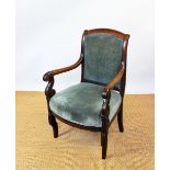 A William IV carved mahogany library chair, with scroll end arms and green upholstery,