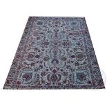 A Persian Tabriz wool carpet, worked with an all over floral design against a pale green ground,