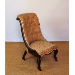 A William IV carved rosewood salon chair, on scroll legs,