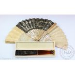 An early 20th century black lace and faux tortoiseshell fan, in a Tiffany & Co box, 55cm open,
