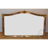 A large Italian gilt wood and gesso wall mirror, with serpentine frame,