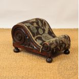 A William IV carved rosewood foot stool, of scroll form, with floral upholstery, on turned feet, 25.