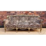 An 18th century style Italian caved gilt wood and gesso salon settee, with elaborate scroll frame,