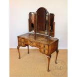A Queen Ann style walnut dressing table, with triple mirror above two drawers,