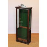 An Edwardian oak gun cabinet, with glazed door and sides,
