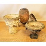 A terracotta garden vase, on iron stand, 70cm, with two smaller garden vases,