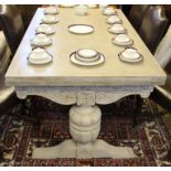 A limed oak extending dining table, with parquetry top, on baluster legs and standard end supports,
