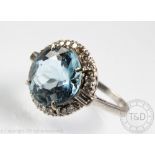 A blue zircon and diamond circular cluster ring,