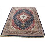 A machine woven carpet, worked with a central medallion and floral design against a blue ground,