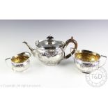 An Edwardian silver three piece service, C S Harris & Sons Ltd, London 1905, comprising; a teapot,