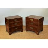 A pair of modern Campaign style walnut bedside chests, on three graduated drawers, on bracket feet,