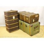 A large early 20th century green canvas and wooden bound steamer trunk,