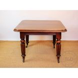 A Victorian mahogany extending dining table, with one leaf, the top with a moulded edge,