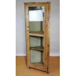An Edwardian pine corner cabinet, with one long door enclosing shelves, on bracket feet,