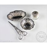 A selection of silver comprising; a pair of silver grape scissors, L & S, Sheffield 1991,
