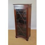 An Edwardian mahogany display cabinet of slender proportions, with astraglazed glazed door,