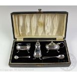 A George VI silver cruet set, Adie Brothers Ltd, Birmingham 1948, with two associated spoons, cased,