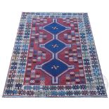 A Persian Shiraz wool rug, worked with three gulls against a red ground,