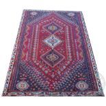 A Caucasian qashqai wool rug, worked with three geometric gulls against a red ground,