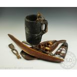 A collection of tribal items to include a carved hardwood water vessel,