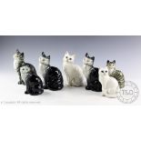 Four Beswick Cats seated, head looks up, model number 1030, designed by Arthur Gredington,