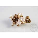 A 9ct gold bead and untested pearl set brooch, import mark circa 1975, makers mark 'TW' and 'CJ Ld',