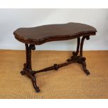 A Victorian walnut stretcher table, with serpentine top, on carved legs, 73cm H x 122cm W x 61cm D,