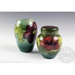 A Moorcroft Clematis pattern vase, the continuous band of blooms against a washed blue ground,