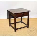 An 18th century Welsh oak side table, with drop leaf back and single drawer with bun handle,