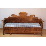 A 19th century Swedish scumbled pine scroll end settee, with later upholstered seat,