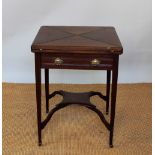 An Edwardian mahogany envelope card table, with drawer, on tapered legs, 74.