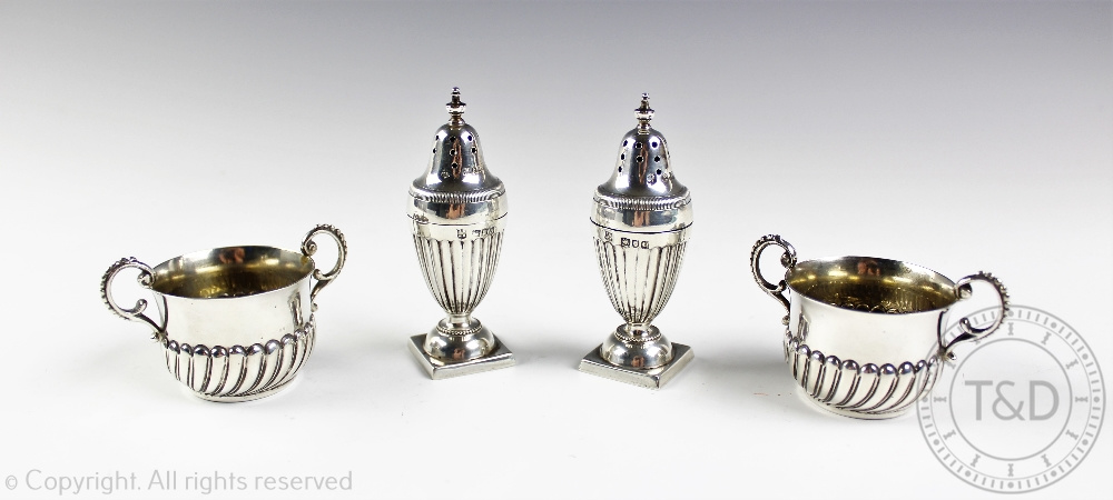 A pair of Victorian silver peppers, James Deakin & Sons, London 1897,