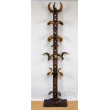 An oak and horn folk art hall stand / hat stand, the upright set with twenty horns,