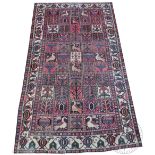 A Persian Bakhtiari garden design wool carpet, worked with fifty five geometric panels against,