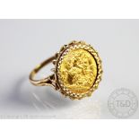 A George V gold half sovereign dated 1911, within 9ct gold ring mount, gross weight 9.