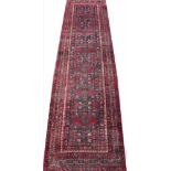 A Persian Heriz full pile wool runner, worked with six geometric gulls against blue / grey ground,