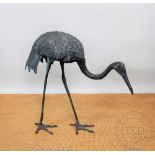 A metal garden statue of a crane,