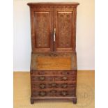A late George III oak bureau bookcase with later carved detailing, possibly Welsh,